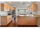 Well-equipped kitchen with wooden cabinets, granite countertops, and stainless steel appliances at 4816 S Elk Way, Aurora, CO 80016
