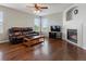 Inviting living room with a fireplace, a ceiling fan, and large windows at 4816 S Elk Way, Aurora, CO 80016