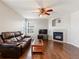 Cozy living room with a fireplace, comfortable seating, and a ceiling fan at 4816 S Elk Way, Aurora, CO 80016