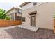 View of the backyard with gravel ground cover and a private rear entrance at 10580 Waco St, Commerce City, CO 80022