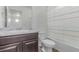 Bathroom featuring a dark vanity, a combination shower/tub, and wood floors at 10580 Waco St, Commerce City, CO 80022
