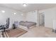 Well lit bedroom features neutral colored carpet, a bed with gray throw, and 3 large windows at 10580 Waco St, Commerce City, CO 80022