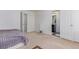 Bedroom leading to an ensuite bath features neutral carpet and a bed with gray comforter at 10580 Waco St, Commerce City, CO 80022