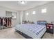 Well lit bedroom featuring a clothing rack, a bed, and bedside tables at 10580 Waco St, Commerce City, CO 80022