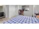 Bedroom leading to an ensuite bathroom features neutral walls and carpet, and a sliding door closet at 10580 Waco St, Commerce City, CO 80022