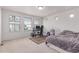 Spacious bedroom featuring multiple windows, neutral carpeting, and a dedicated desk/office space at 10580 Waco St, Commerce City, CO 80022