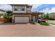 Charming two-story home boasts a brick driveway, attached two-car garage, and inviting front porch at 10580 Waco St, Commerce City, CO 80022