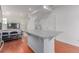 Bright kitchen with an island, hardwood floors, white cabinets, and stainless steel refrigerator at 10580 Waco St, Commerce City, CO 80022