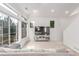 Bright living space features a plush sofa, large windows, and a modern entertainment center with television at 10580 Waco St, Commerce City, CO 80022