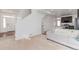 Bright living space features a plush sofa, fresh neutral paint, and seamless flow into the kitchen area at 10580 Waco St, Commerce City, CO 80022