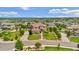 Aerial view of an estate featuring lush landscaping, mature trees, and a terracotta roof at 7724 Kryptonite Ln, Castle Rock, CO 80108