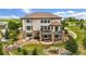 Spacious backyard featuring a deck, patio, fire pit, pond and beautiful landscaping at 7724 Kryptonite Ln, Castle Rock, CO 80108