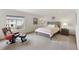 Bright bedroom with a comfy chair, ottoman and a decorative headboard at 7724 Kryptonite Ln, Castle Rock, CO 80108