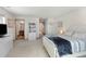 Bedroom featuring a queen bed, built-in bookcase, and an en-suite bathroom at 7724 Kryptonite Ln, Castle Rock, CO 80108