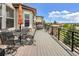 Outdoor deck with dining and lounge seating and wrought iron railing at 7724 Kryptonite Ln, Castle Rock, CO 80108