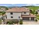 Charming home featuring a terracotta roof, an attached garage, and a stone facade at 7724 Kryptonite Ln, Castle Rock, CO 80108
