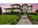 Elegant home featuring a meticulously landscaped yard, stone accents, and a charming walkway to the front entrance at 7724 Kryptonite Ln, Castle Rock, CO 80108