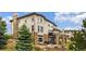 Exterior view of the house with a spiral staircase, outdoor fireplace and patio at 7724 Kryptonite Ln, Castle Rock, CO 80108