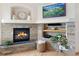 Charming fireplace featuring stone surround, a mantel, and built-in shelving, creating a cozy and inviting ambiance at 7724 Kryptonite Ln, Castle Rock, CO 80108