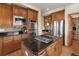 Modern kitchen with granite countertops, stainless steel appliances, a central island, and custom wood cabinetry at 7724 Kryptonite Ln, Castle Rock, CO 80108