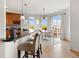 Inviting kitchen and breakfast nook with bar seating, hardwood floors, scenic views, and access to an outdoor space at 7724 Kryptonite Ln, Castle Rock, CO 80108