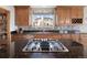 Well-appointed kitchen with granite countertops, custom cabinetry, stainless steel appliances, and a gas cooktop at 7724 Kryptonite Ln, Castle Rock, CO 80108