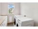 Bright laundry room featuring a side-by-side washer and dryer, sink, and a window providing natural light at 7724 Kryptonite Ln, Castle Rock, CO 80108