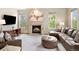 Bright living room featuring a cozy fireplace, comfortable seating, and abundant natural light at 7724 Kryptonite Ln, Castle Rock, CO 80108