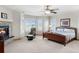 Main bedroom with natural light, sitting area, and fireplace at 7724 Kryptonite Ln, Castle Rock, CO 80108