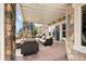 Covered patio with comfortable seating and a spiral staircase at 7724 Kryptonite Ln, Castle Rock, CO 80108