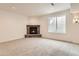 Finished basement featuring a corner fireplace and a large window at 7746 S Joplin Ct, Englewood, CO 80112