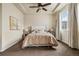Bright bedroom featuring a ceiling fan, large window, and a bed with luxury bedding at 9071 E Phillips Dr, Centennial, CO 80112