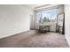 Bright bedroom featuring a work desk, large window with neighborhood views at 9071 E Phillips Dr, Centennial, CO 80112