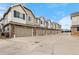 Townhome row features attached garages, neat landscaping, and durable siding creating curb appeal at 9071 E Phillips Dr, Centennial, CO 80112