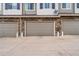 Attached garages with neutral doors and stone accents for convenient parking and storage at 9071 E Phillips Dr, Centennial, CO 80112