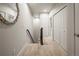Carpeted hallway with white doors and a decorative mirror at 9071 E Phillips Dr, Centennial, CO 80112