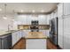 Well-equipped kitchen boasts stainless steel appliances, granite counters, and white cabinets at 9071 E Phillips Dr, Centennial, CO 80112