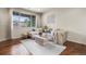 Comfortable living room with a large window offering natural light and cozy furniture at 9071 E Phillips Dr, Centennial, CO 80112