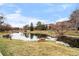 Scenic pond view surrounded by landscaping and nearby townhomes creates peaceful setting at 9071 E Phillips Dr, Centennial, CO 80112
