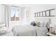 Inviting bedroom featuring stylish bedding, a picturesque window view, and charming ladder decor at 1415 N Washington St # 303, Denver, CO 80203