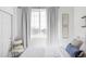 Bright bedroom with a comfortable bed, picturesque window view, and tasteful wall decor at 1415 N Washington St # 303, Denver, CO 80203