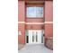 Close-up of the apartment building entrance with a modern double door and brick facade at 1415 N Washington St # 303, Denver, CO 80203