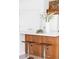 Close-up of a kitchen island with bar stools, white countertop, and decorative floral arrangements at 1415 N Washington St # 303, Denver, CO 80203
