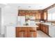 Modern kitchen with white countertops, stainless steel appliances, a breakfast bar, and exposed brick at 1415 N Washington St # 303, Denver, CO 80203