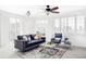 Inviting living room with large windows, modern ceiling fan, and a comfortable seating arrangement at 1415 N Washington St # 303, Denver, CO 80203