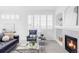 Bright living room with large windows, fireplace, and stylish furniture for comfortable living at 1415 N Washington St # 303, Denver, CO 80203