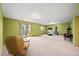 Spacious basement featuring a sliding glass door, a cozy wood-burning stove, and comfortable seating at 29825 Kennedy Gulch Rd, Conifer, CO 80433