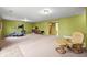 Large basement space with a wood-burning stove, comfortable seating and access to other rooms at 29825 Kennedy Gulch Rd, Conifer, CO 80433