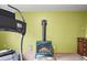 Basement area featuring a modern treadmill and a cozy wood-burning stove, creating a versatile space at 29825 Kennedy Gulch Rd, Conifer, CO 80433