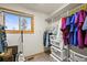 Walk-in closet with organized shelves and storage and a window that provides natural light at 29825 Kennedy Gulch Rd, Conifer, CO 80433